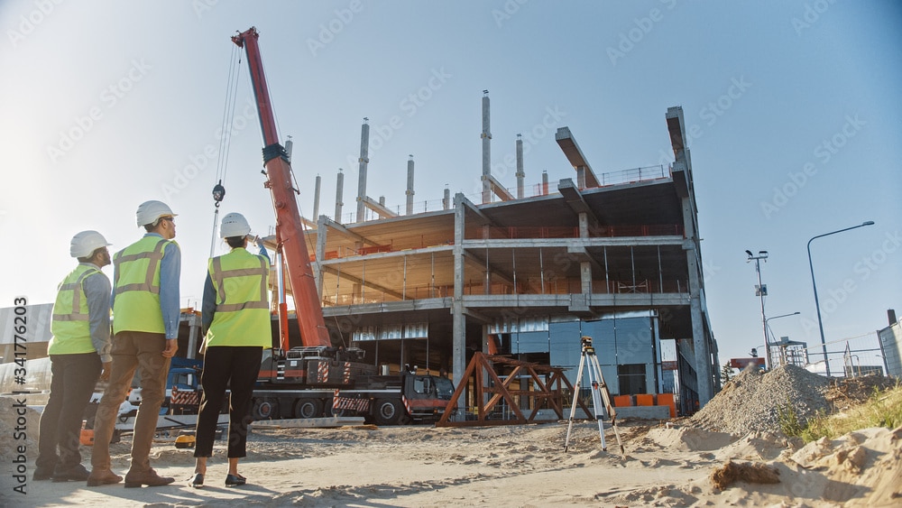 three people supervising a construction